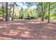 Expansive yard with mature trees surrounding a well-maintained home at 2701 East Mill Sw Way, Conyers, GA 30094