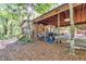 Backyard of house with screened-in porch and outdoor grilling equipment and picnic table at 2701 East Mill Sw Way, Conyers, GA 30094