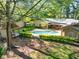 View of backyard swimming pool, gazebo, mature trees and lush landscaping at 2701 East Mill Sw Way, Conyers, GA 30094