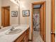 Bathroom with double sinks, wood cabinets, and nautical-themed shower curtain at 2701 East Mill Sw Way, Conyers, GA 30094