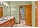 Green bathroom with wood vanity and a separate toilet and shower area at 2701 East Mill Sw Way, Conyers, GA 30094