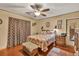 Bright bedroom with laminate wood floors, ceiling fan, and decorative touches at 2701 East Mill Sw Way, Conyers, GA 30094