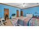 Blue bedroom features a large bed, ceiling fan, and lots of natural light at 2701 East Mill Sw Way, Conyers, GA 30094