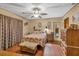 Comfortable bedroom featuring wood laminate flooring and a ceiling fan at 2701 East Mill Sw Way, Conyers, GA 30094