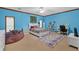 A blue bedroom with ample space, decorated with modern décor including a desk and rug at 2701 East Mill Sw Way, Conyers, GA 30094