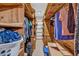 A walk in closet with extensive wood shelving, loaded with clothes and storage boxes at 2701 East Mill Sw Way, Conyers, GA 30094