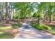 Long driveway with a gated entrance through landscaped yard at 2701 East Mill Sw Way, Conyers, GA 30094