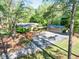 Charming single-story home with a long driveway leading to a detached garage, and mature trees at 2701 East Mill Sw Way, Conyers, GA 30094