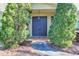 Front entrance featuring double doors with mature landscaping around entryway at 2701 East Mill Sw Way, Conyers, GA 30094