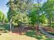 Serene front yard view with mature trees and manicured landscaping, offering a peaceful ambiance at 2701 East Mill Sw Way, Conyers, GA 30094