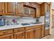 Close-up of the kitchen area featuring custom wood cabinetry and stainless steel appliances at 2701 East Mill Sw Way, Conyers, GA 30094