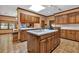 Spacious kitchen featuring an island with a sink, custom cabinets, and a view to the dining area at 2701 East Mill Sw Way, Conyers, GA 30094