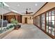 Bright living room with built-in shelving, a ceiling fan, and multiple glass doors to the outdoors at 2701 East Mill Sw Way, Conyers, GA 30094