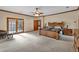 Large main bedroom with wooden furniture, ceiling fan, and natural light at 2701 East Mill Sw Way, Conyers, GA 30094