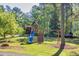 Backyard with a wooden playground, swing set, and slide at 2701 East Mill Sw Way, Conyers, GA 30094