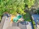 Aerial view of backyard pool with surrounding deck and manicured greenery at 2701 East Mill Sw Way, Conyers, GA 30094