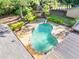 Aerial view of a kidney-shaped pool with a diving board, cabana, and well-maintained patio at 2701 East Mill Sw Way, Conyers, GA 30094