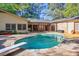 Outdoor pool area surrounded by patio and grassy backyard at 2701 East Mill Sw Way, Conyers, GA 30094