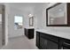 Bright bathroom featuring double vanities, modern fixtures, and a framed mirror at 3764 Sage Park Way, Suwanee, GA 30024