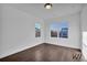 Bedroom with hardwood floors, white walls, and large windows allowing natural light at 3764 Sage Park Way, Suwanee, GA 30024