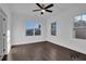 Inviting bedroom with hardwood floors, natural light, and a ceiling fan at 3764 Sage Park Way, Suwanee, GA 30024
