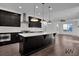 Stylish kitchen featuring a large island, stainless steel appliances, and modern lighting at 3764 Sage Park Way, Suwanee, GA 30024