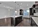 Contemporary kitchen with an island, stainless steel appliances, and hardwood floors at 3764 Sage Park Way, Suwanee, GA 30024