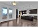 Modern kitchen with a large island, stainless steel appliances, and access to the deck at 3764 Sage Park Way, Suwanee, GA 30024