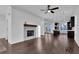 Spacious living room with a fireplace, hardwood floors, and ample natural light at 3764 Sage Park Way, Suwanee, GA 30024