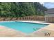 A well-maintained community pool offers a refreshing escape with lush greenery in the background at 3764 Sage Park Way, Suwanee, GA 30024