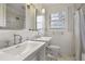 Bright bathroom with dual sinks, marble tile, and a window providing natural light at 1794 Charline Ne Ave, Atlanta, GA 30306