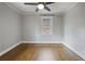 Cozy bedroom with hardwood floors, ceiling fan, and a large window at 1794 Charline Ne Ave, Atlanta, GA 30306