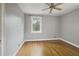 Neutral bedroom with hardwood floors, ceiling fan, and a large window at 1794 Charline Ne Ave, Atlanta, GA 30306