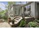 Lovely white brick home with exterior chairs, stone staircase, and lush foliage on a sunny day at 1794 Charline Ne Ave, Atlanta, GA 30306