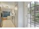Elegant kitchen leading to the backyard with white cabinets, stainless steel appliances, and chevron flooring at 1794 Charline Ne Ave, Atlanta, GA 30306