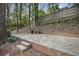 Spacious stone patio with brick accents and a built-in fireplace at 1794 Charline Ne Ave, Atlanta, GA 30306