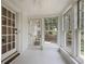 Bright sunroom featuring white-painted floors, lots of natural light and views of the surrounding greenery at 1794 Charline Ne Ave, Atlanta, GA 30306