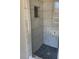 Tiled shower offers mosaic floor, marble walls and convenient storage niche at 2250 Camp Town Way, Lawrenceville, GA 30044