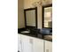 Bathroom vanity with black granite countertop and dual sinks at 2250 Camp Town Way, Lawrenceville, GA 30044
