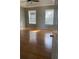 Bedroom boasts hardwood floors, neutral paint, and large window at 2250 Camp Town Way, Lawrenceville, GA 30044