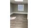 Bedroom with neutral walls, stylish floors, and a bright window at 2250 Camp Town Way, Lawrenceville, GA 30044
