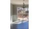 Bright dining area features modern chandelier, gray plank flooring, and glass patio doors at 2250 Camp Town Way, Lawrenceville, GA 30044