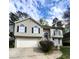 Attractive exterior view of a home featuring a two-car garage, a well-manicured lawn, and arched windows at 2250 Camp Town Way, Lawrenceville, GA 30044