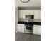Stainless steel oven and microwave compliment white cabinets and dark countertop at 2250 Camp Town Way, Lawrenceville, GA 30044