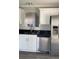 Modern kitchen featuring stainless steel appliances, granite countertops, and white cabinetry at 2250 Camp Town Way, Lawrenceville, GA 30044