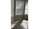 Sunlit living area featuring large windows with white blinds and updated flooring at 2250 Camp Town Way, Lawrenceville, GA 30044