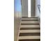 Entry staircase with freshly painted white risers and brown treads leads to a bright entryway at 2250 Camp Town Way, Lawrenceville, GA 30044