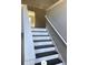 Interior view of stairs with white risers and dark wood treads leading up to the next level at 2250 Camp Town Way, Lawrenceville, GA 30044