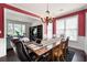 Elegant dining room featuring a large wooden table, chandelier, and access to the living room at 3225 Warren Creek Sw Dr, Hiram, GA 30141
