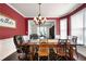 Elegant dining room featuring a large wooden table, chandelier, and access to the living room at 3225 Warren Creek Sw Dr, Hiram, GA 30141